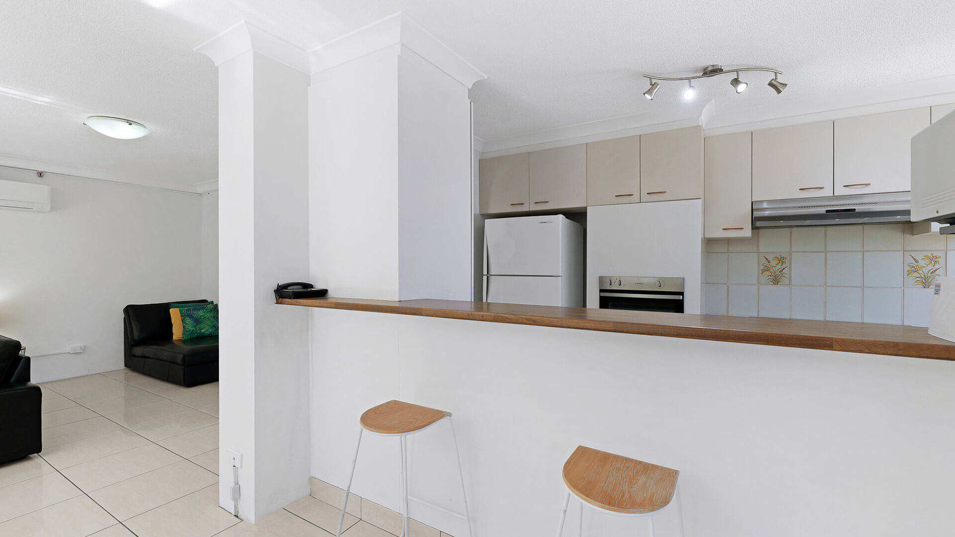 Kitchen breakfast bar with two stools in the 2 Bedroom Apartment at ULTIQA Beach Haven.