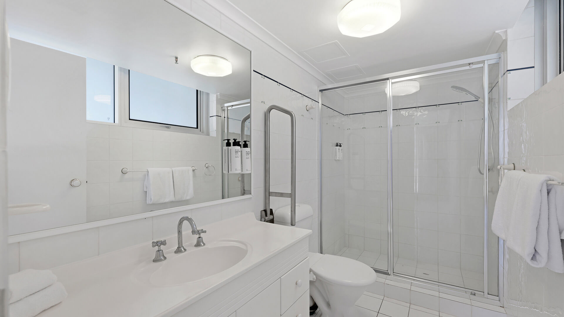 Main bathroom with walk-in shower and large vanity in the 2 Bedroom Apartment at ULTIQA Beach Haven.