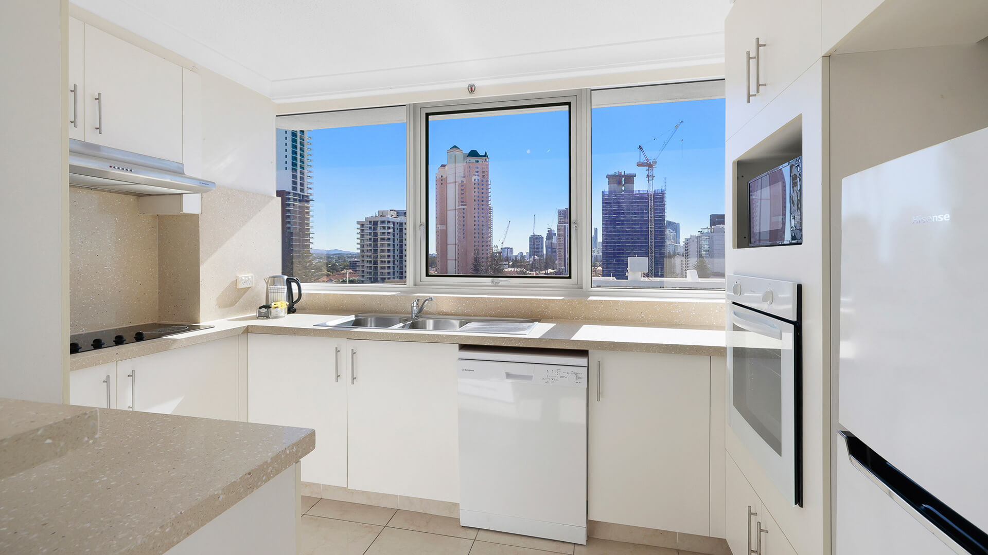 Fully equipped kitchen with city views in the Standard 2 Bedroom Ocean View Apartment at ULTIQA Beach Haven.