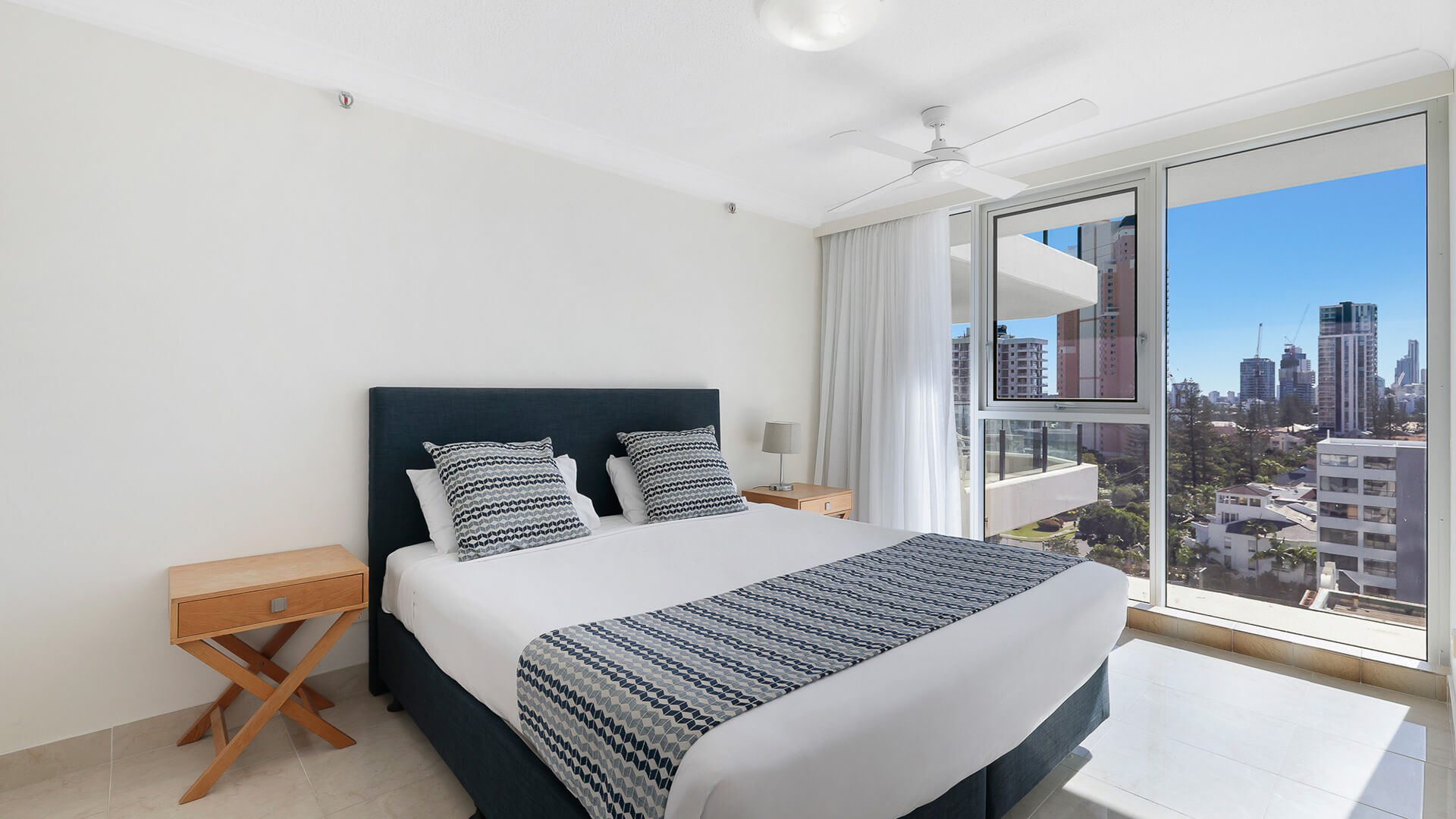 Main bedroom with city views in the Standard 2 Bedroom Ocean View Apartment at ULTIQA Beach Haven.