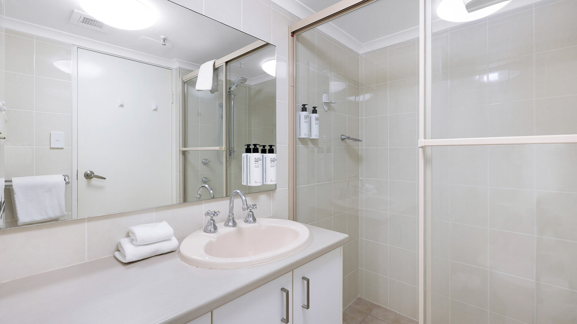 Bathroom in the Standard 2 Bedroom Ocean View Apartment at ULTIQA Beach Haven featuring a walk-in shower and vanity.