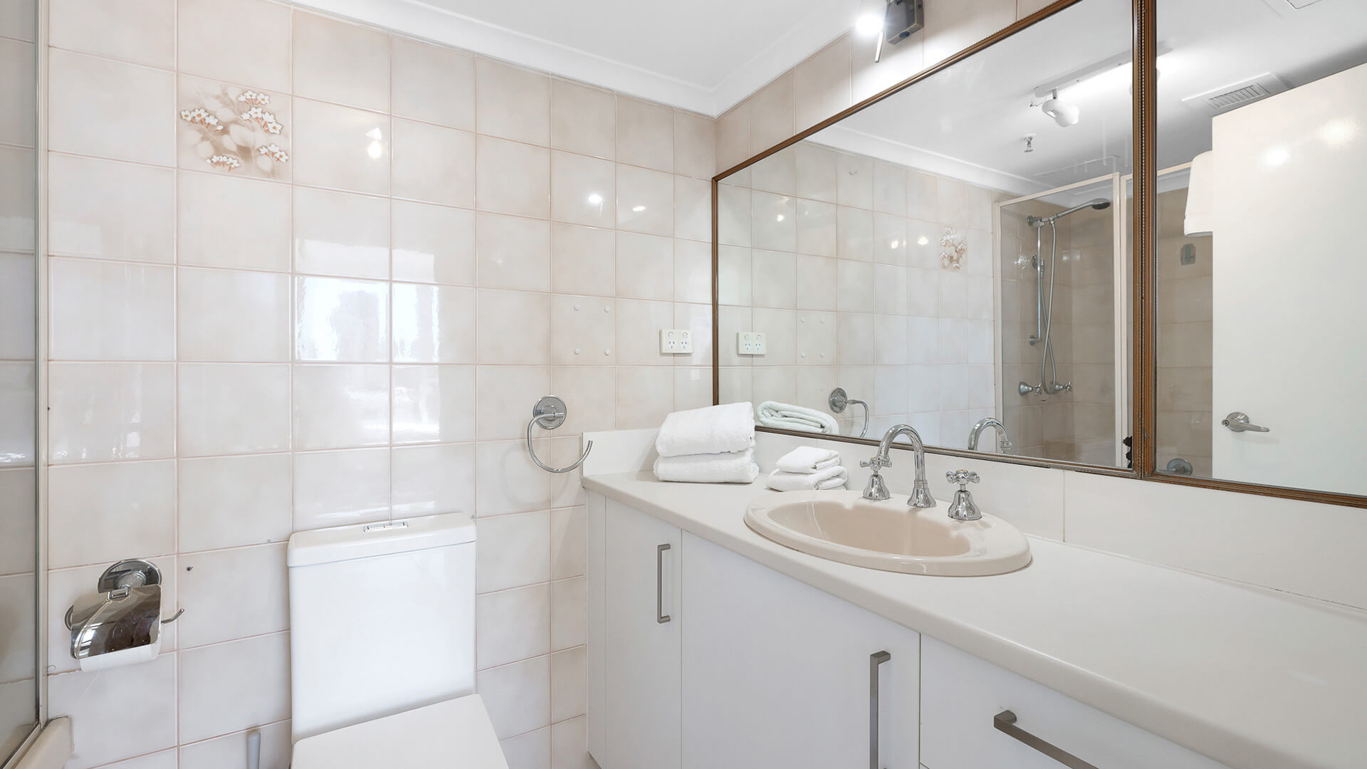 Bathroom in the Standard 2 Bedroom Ocean View Apartment at ULTIQA Beach Haven with a large vanity, wall mirror, and shower-over-bath combo.
