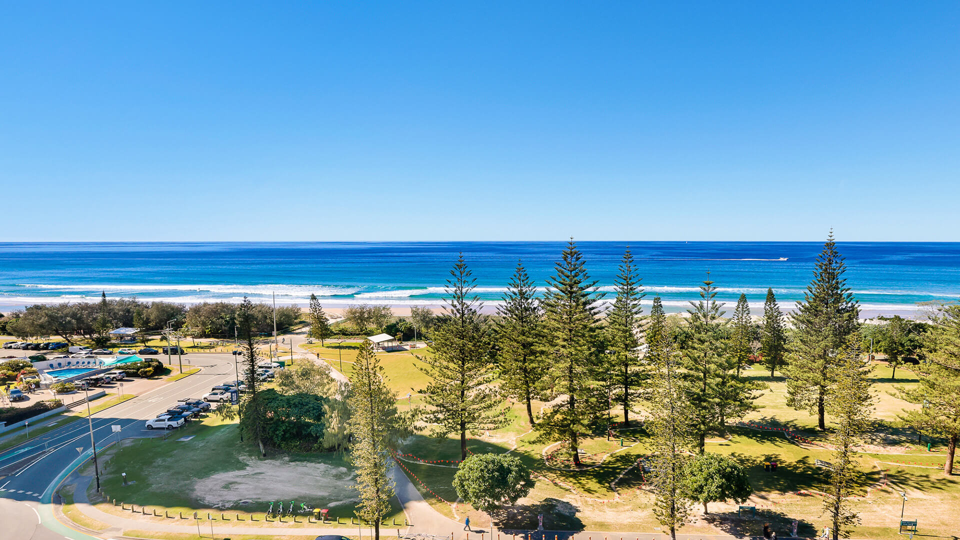 Panoramic ocean views over parklands and Burleigh Beach from ULTIQA Beach Haven’s Standard 2 Bedroom Ocean View Apartment.