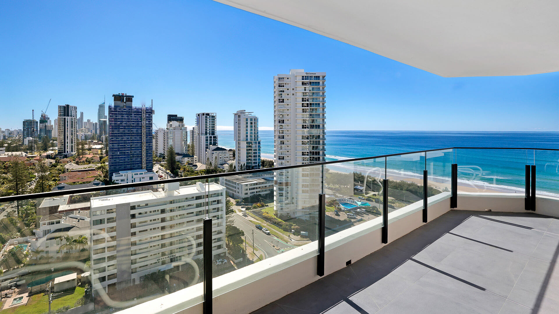 Spacious balcony with panoramic ocean and skyline views at the Standard 2 Bedroom Ocean View Apartment at ULTIQA Beach Haven.
