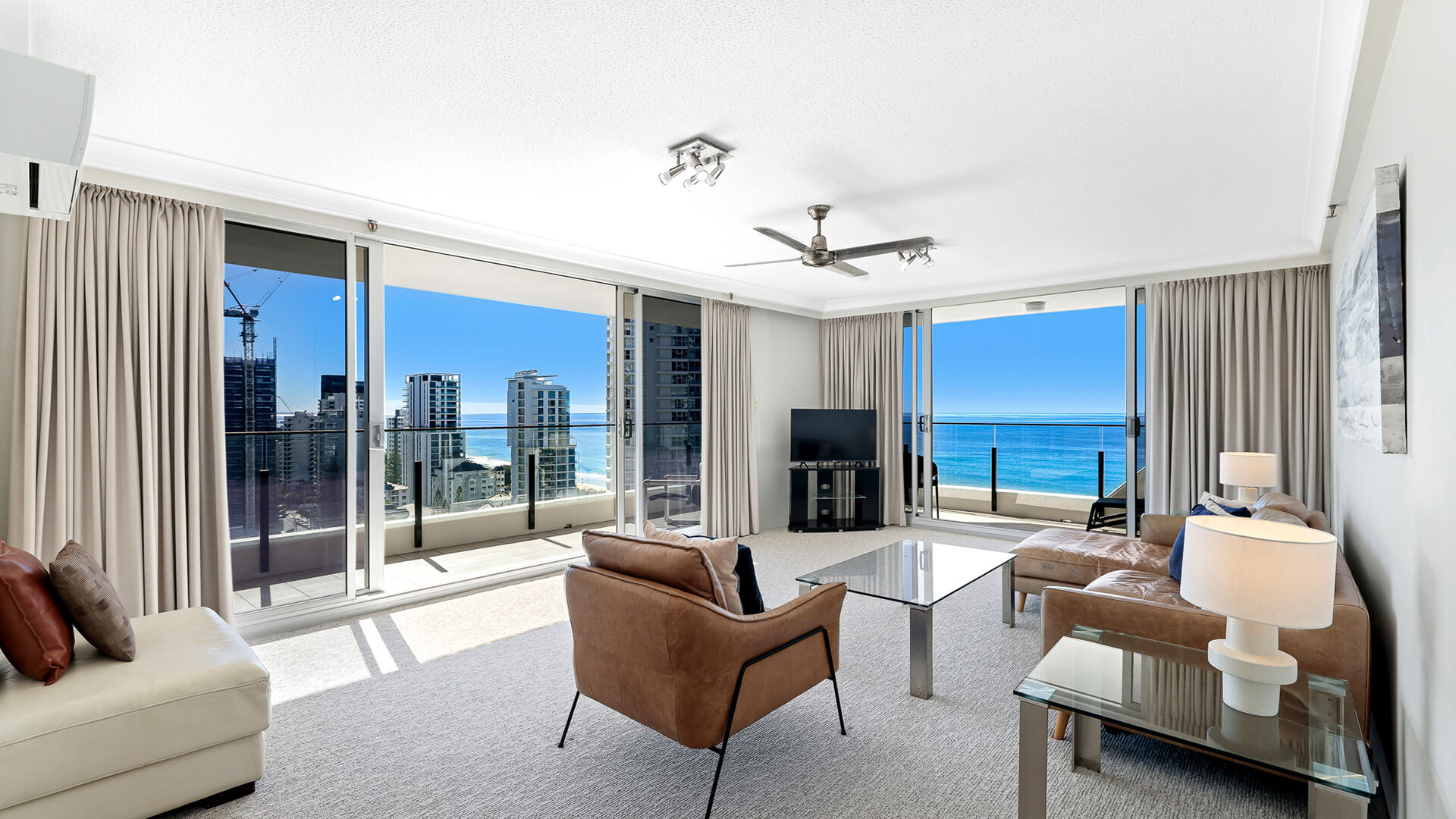 Spacious living room in the 2 Bedroom Ocean View Apartment at ULTIQA Beach Haven with floor-to-ceiling windows and sweeping ocean views.