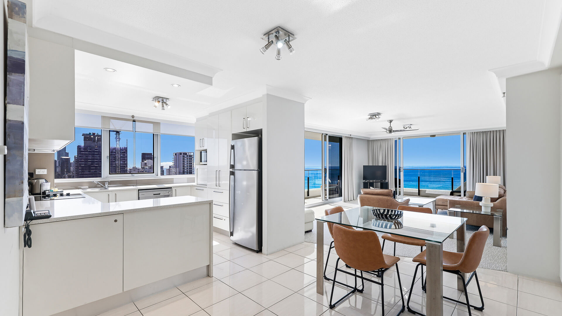 Open-plan kitchen, dining, and living area in the 2 Bedroom Ocean View Apartment at ULTIQA Beach Haven with full-length ocean views.