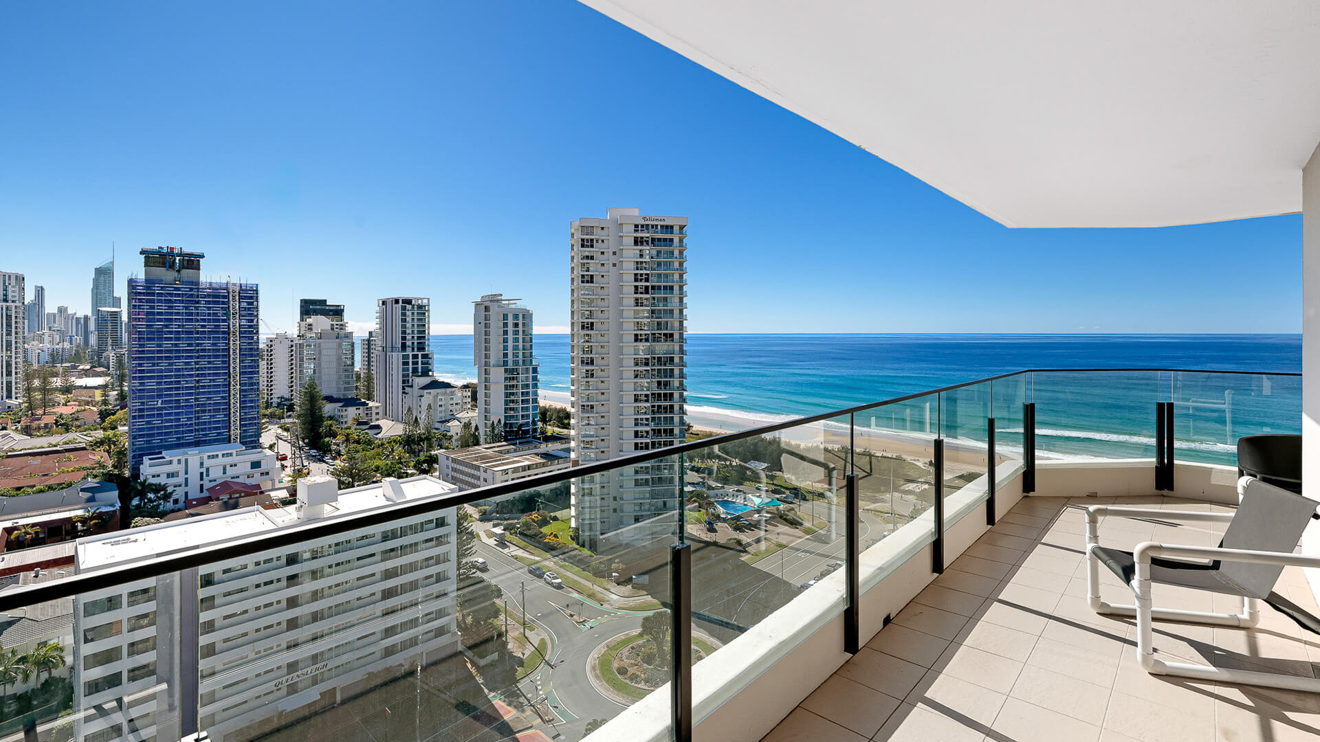 Private balcony at ULTIQA Beach Haven’s 2 Bedroom Ocean View Apartment with panoramic views of the coastline and city skyline.