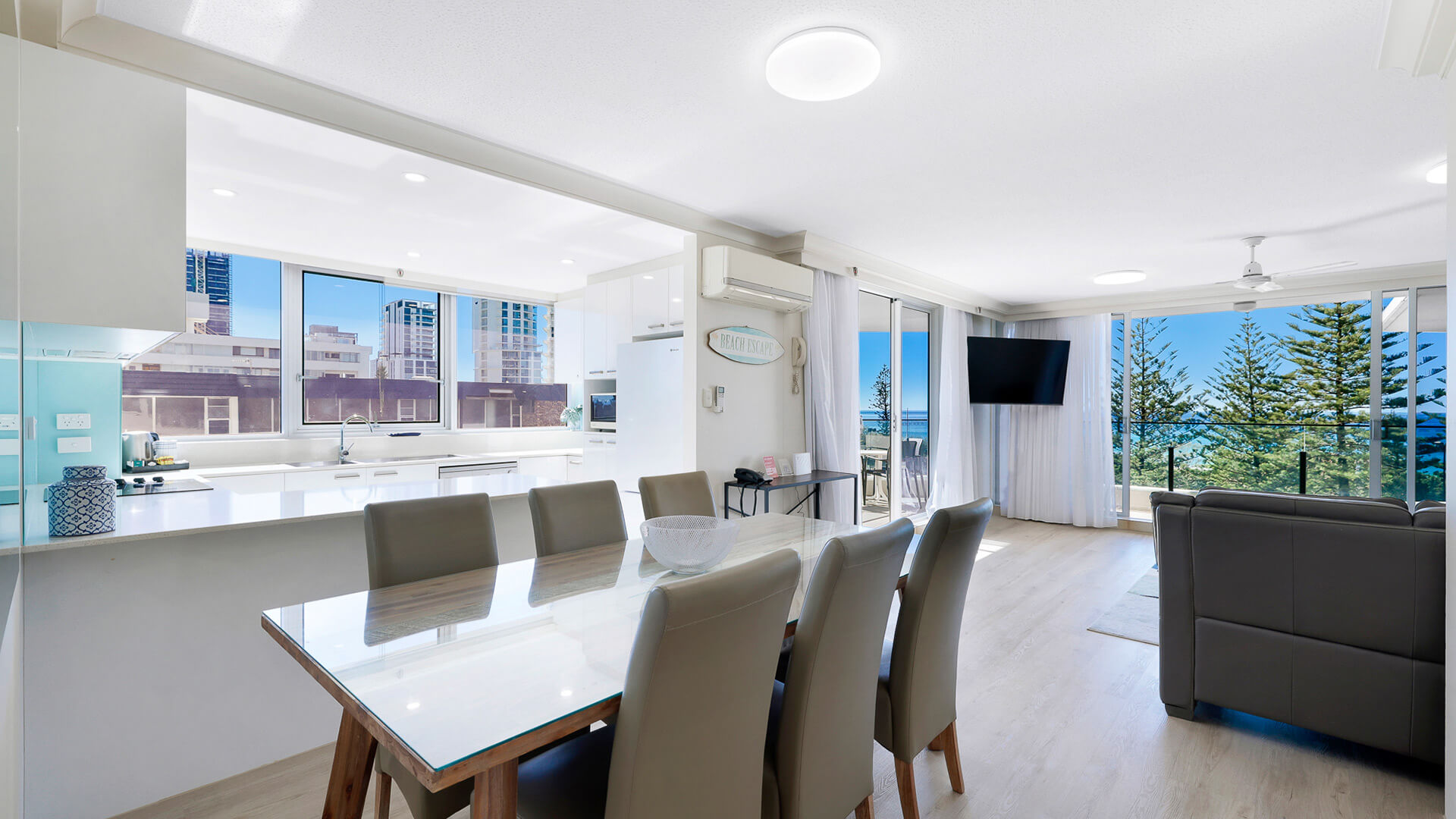 Open-plan kitchen, dining, and living area in the 2 Bedroom Ocean View Apartment at ULTIQA Beach Haven with ocean views and balcony access.