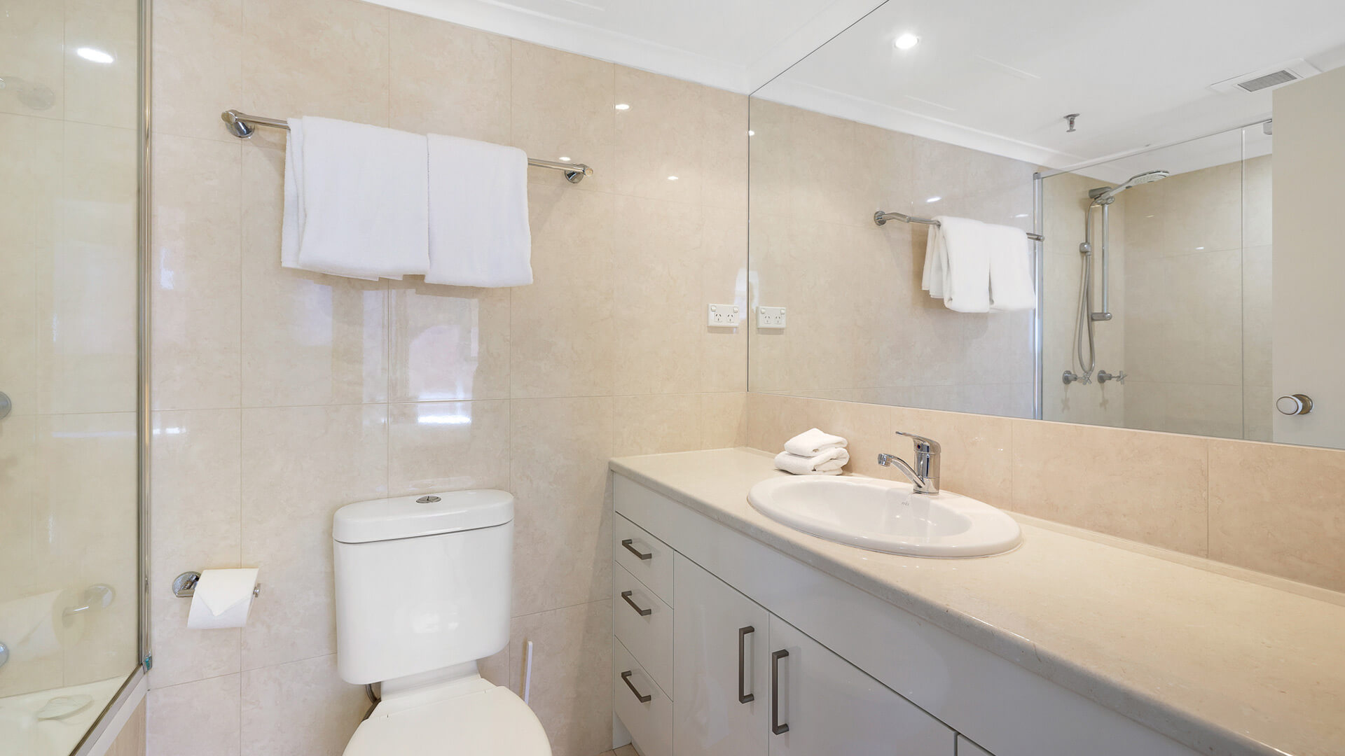 Second bathroom in the 2 Bedroom Ocean View Apartment at ULTIQA Beach Haven with shower over bath and modern vanity.