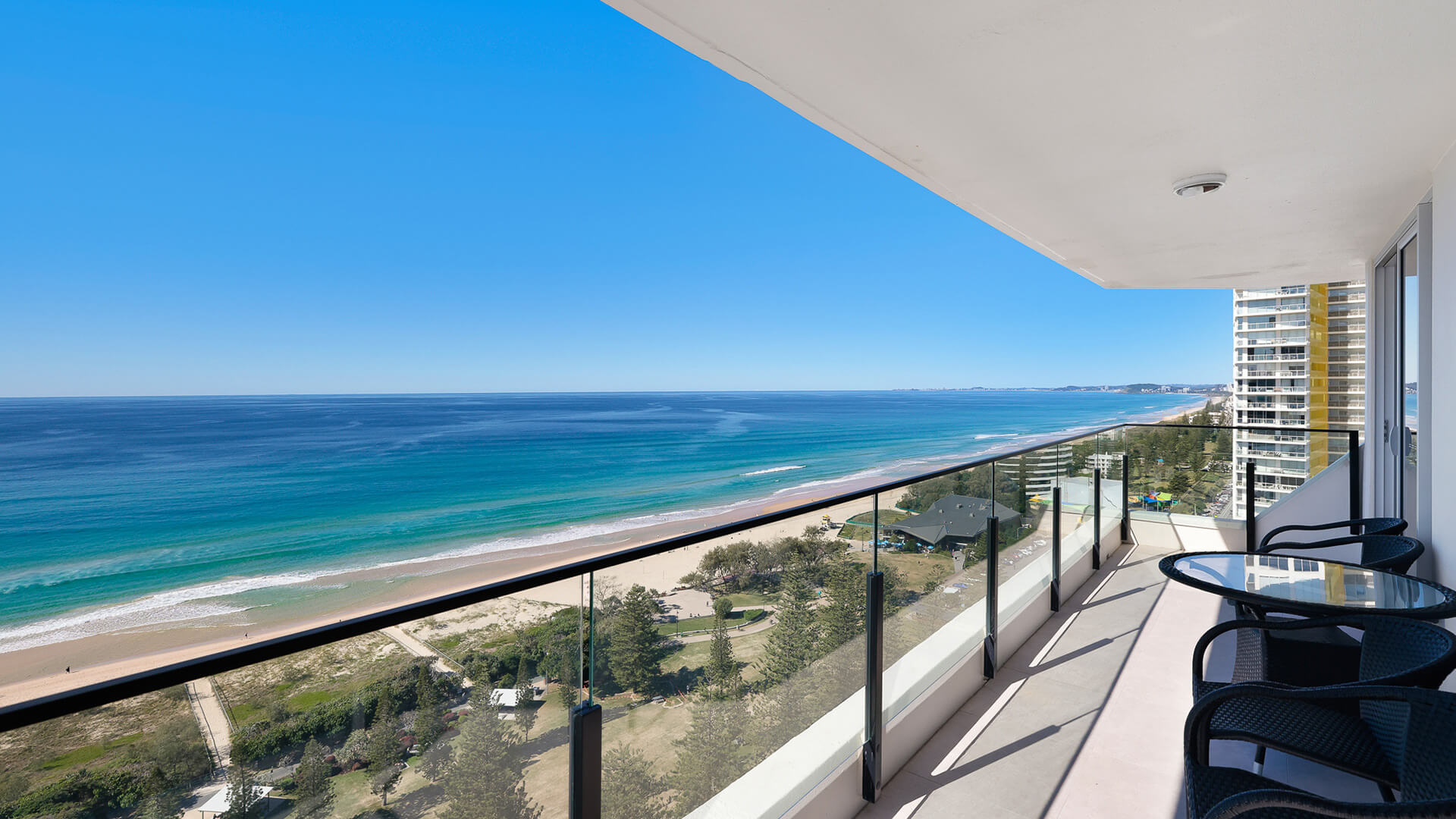 Spacious balcony with sweeping ocean, featuring outdoor seating perfect for relaxing by the sea.