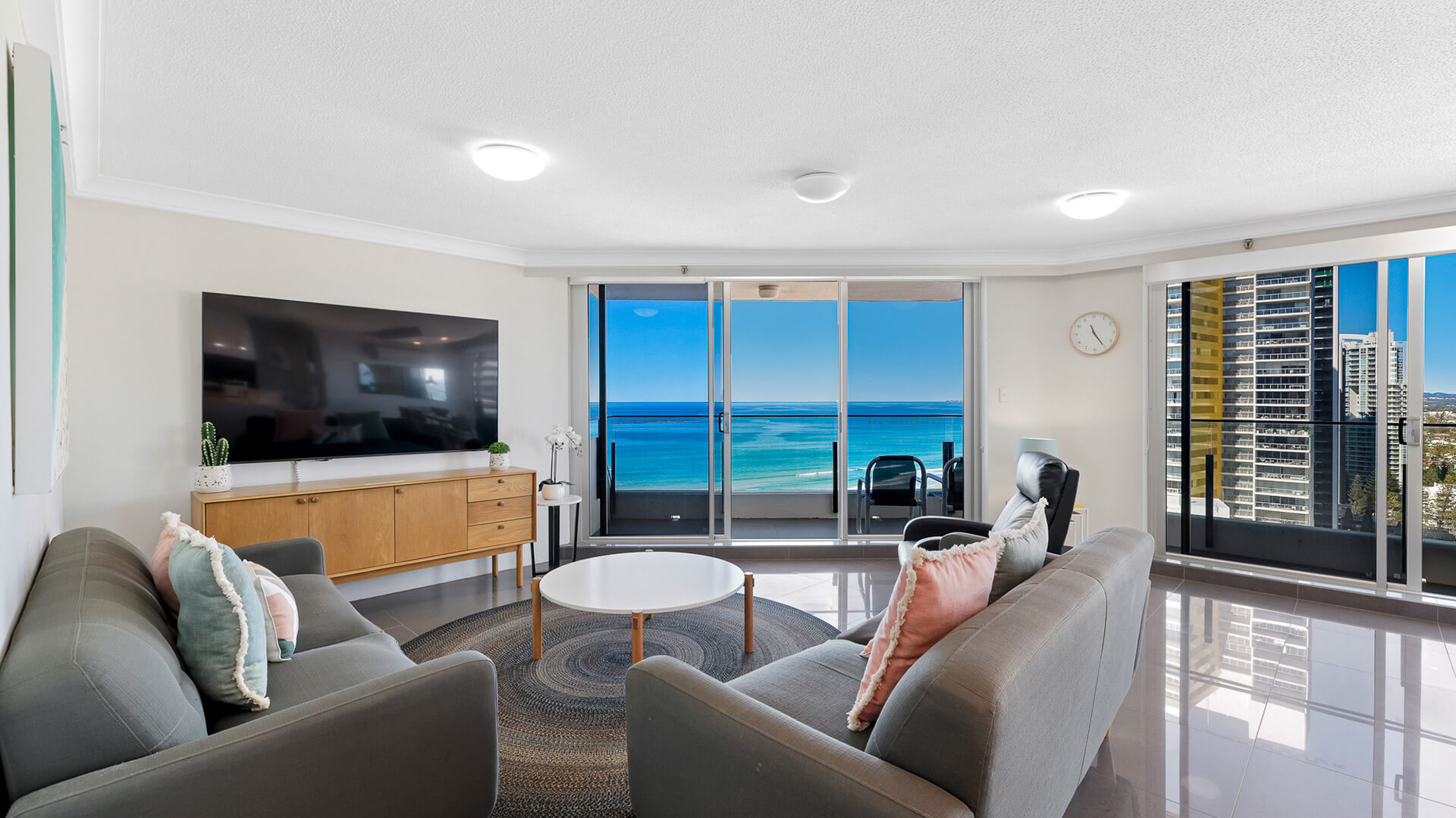 Bright and spacious living area in the Premium 2 Bedroom Ocean View Apartment at ULTIQA Beach Haven with ocean views and access to a private balcony.
