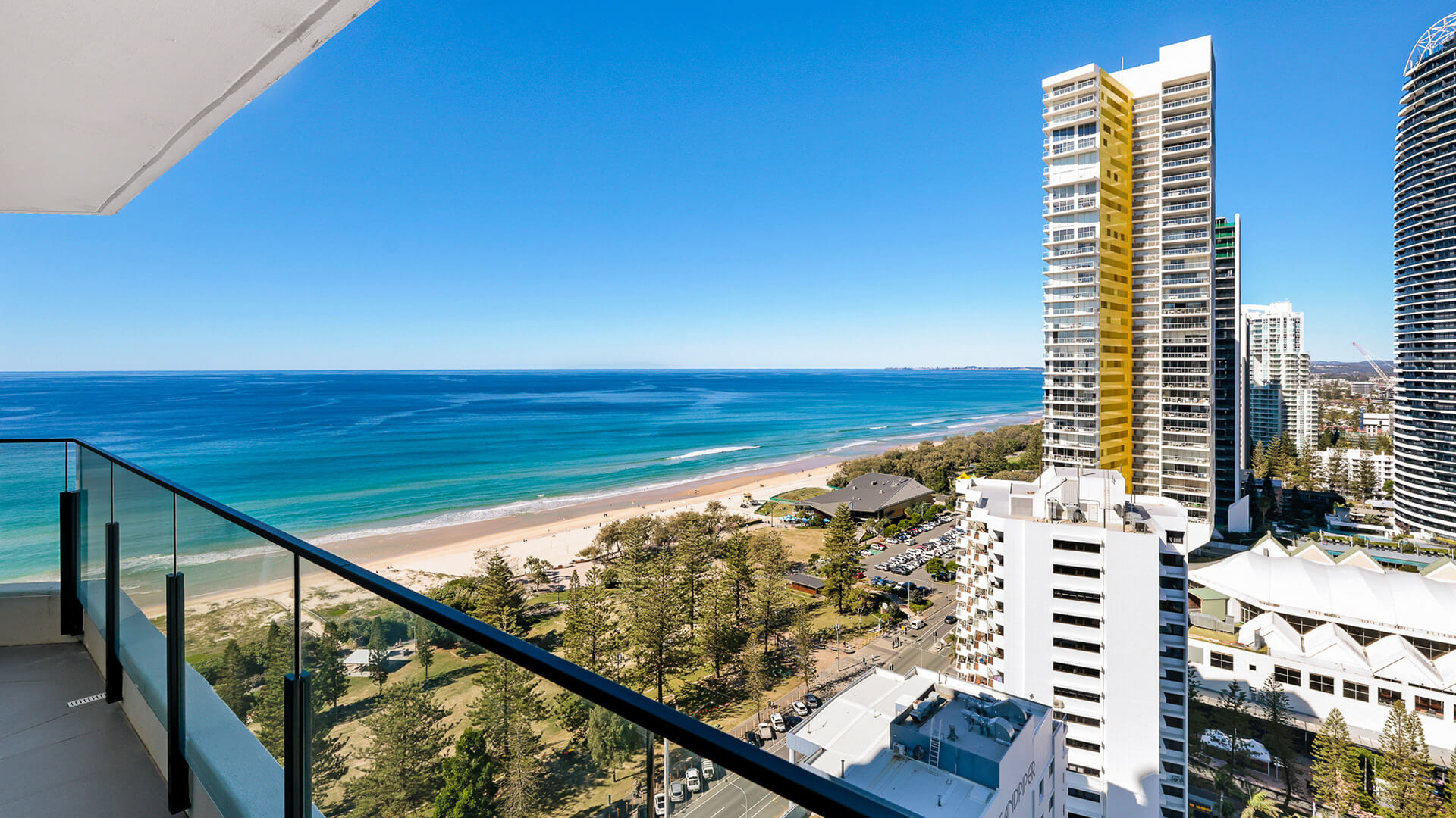 Expansive balcony view overlooking the sparkling ocean and golden sands of Broadbeach.