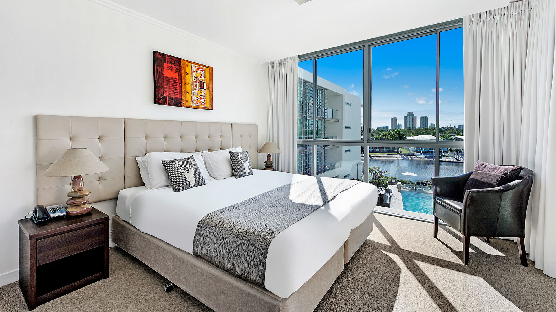 1 Bedroom Apartment at ULTIQA Freshwater Point Resort with water and pool views.