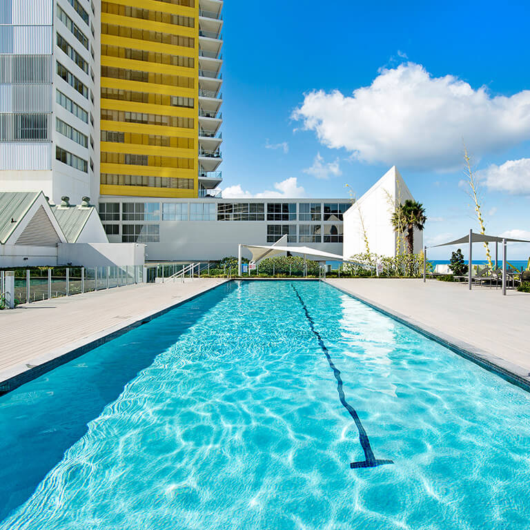 Outdoor lap pool at ULTIQA Air on Broadbeach with ocean views.