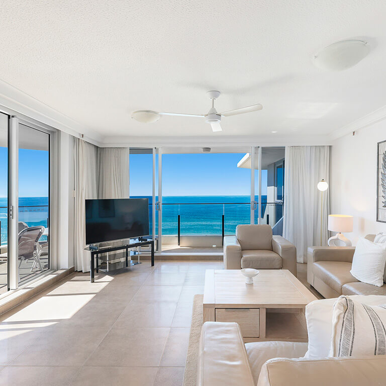 Living area with balcony access and stunning ocean views in the 2 Bedroom Ocean View Apartment at ULTIQA Beach Haven on Broadbeach.