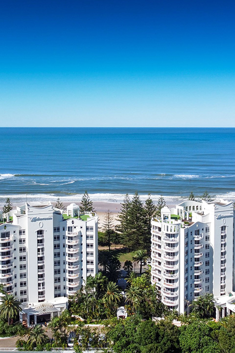 Aerial view of ULTIQA Burleigh Mediterranean Resort with beachfront location and ocean backdrop on the Gold Coast.