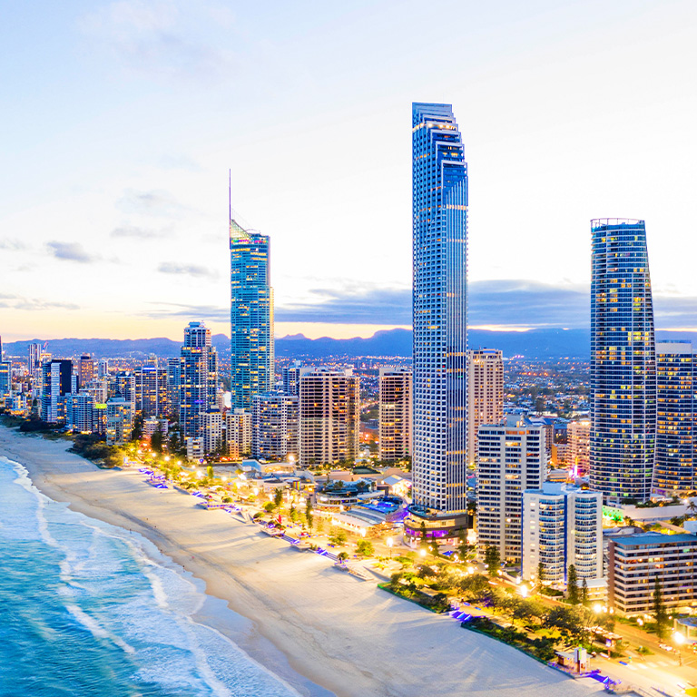 Aerial view of Surfers Paradise skyline and beachfront on the Gold Coast at dusk.