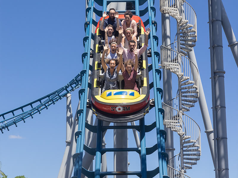 Thrill-seekers riding a looping roller coaster at a Gold Coast theme park.