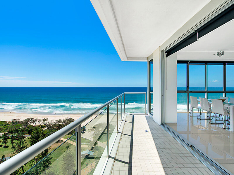 Ocean-view balcony and dining area overlooking the beach from an apartment at ULTIQA Air on Broadbeach.