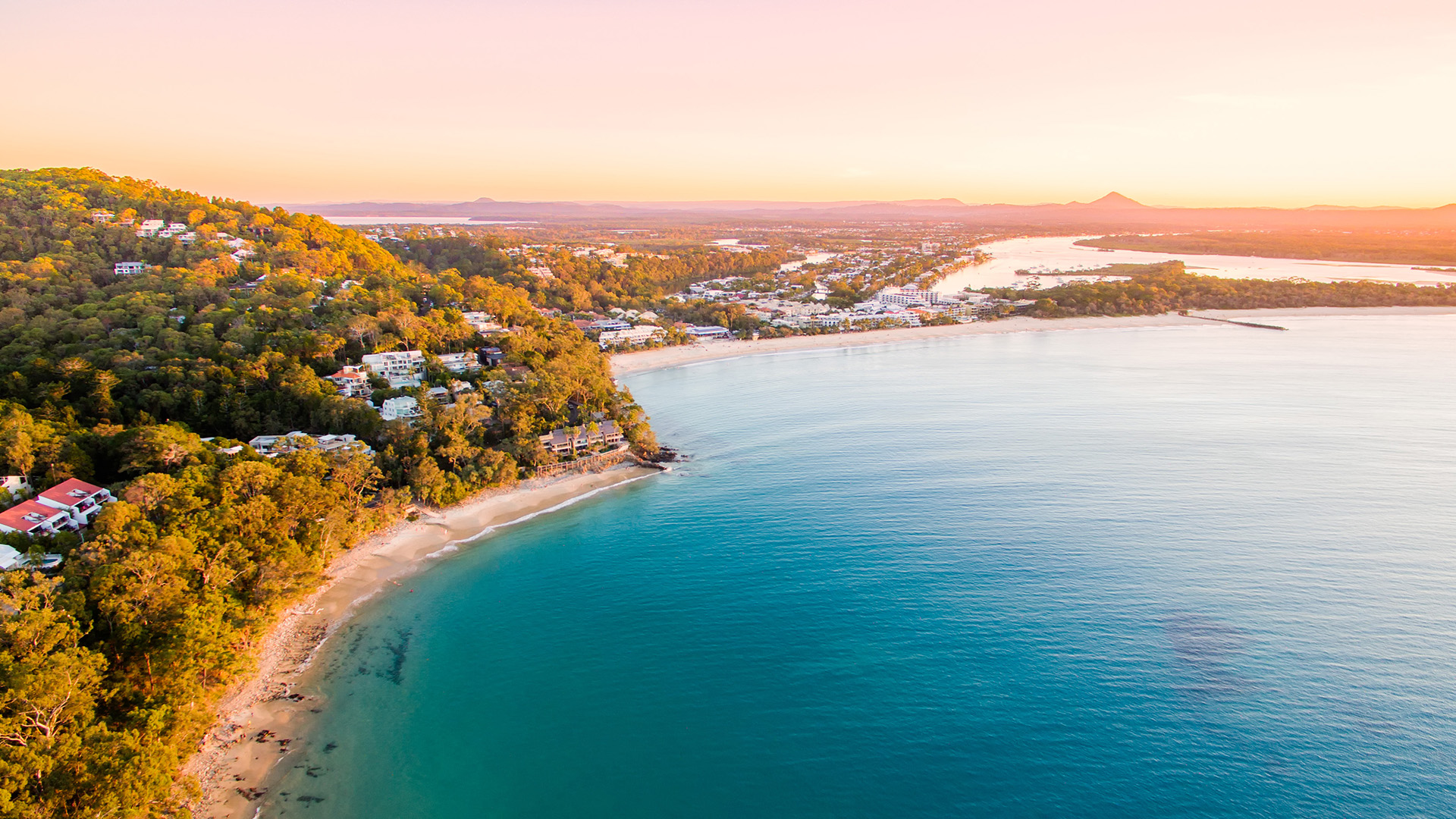Aerial view of Sunshine Coast coastline at sunrise.