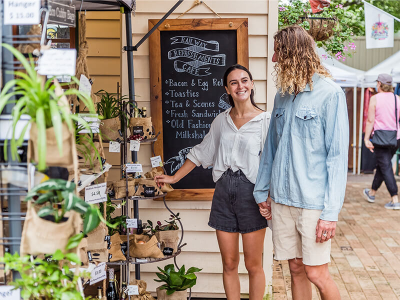 Couple shopping at a market stall on the Sunshine Coast.