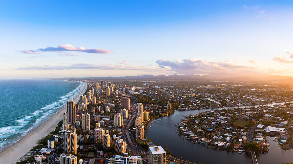 Tropical palm-lined beach with white sand and turquoise waters in Fiji.