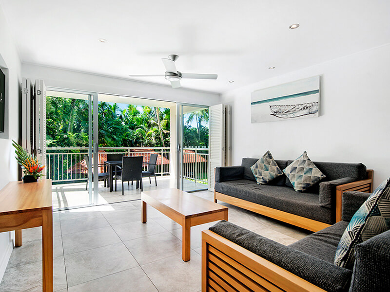 Living area with balcony at ULTIQA Fiji Palms Beach Resort.