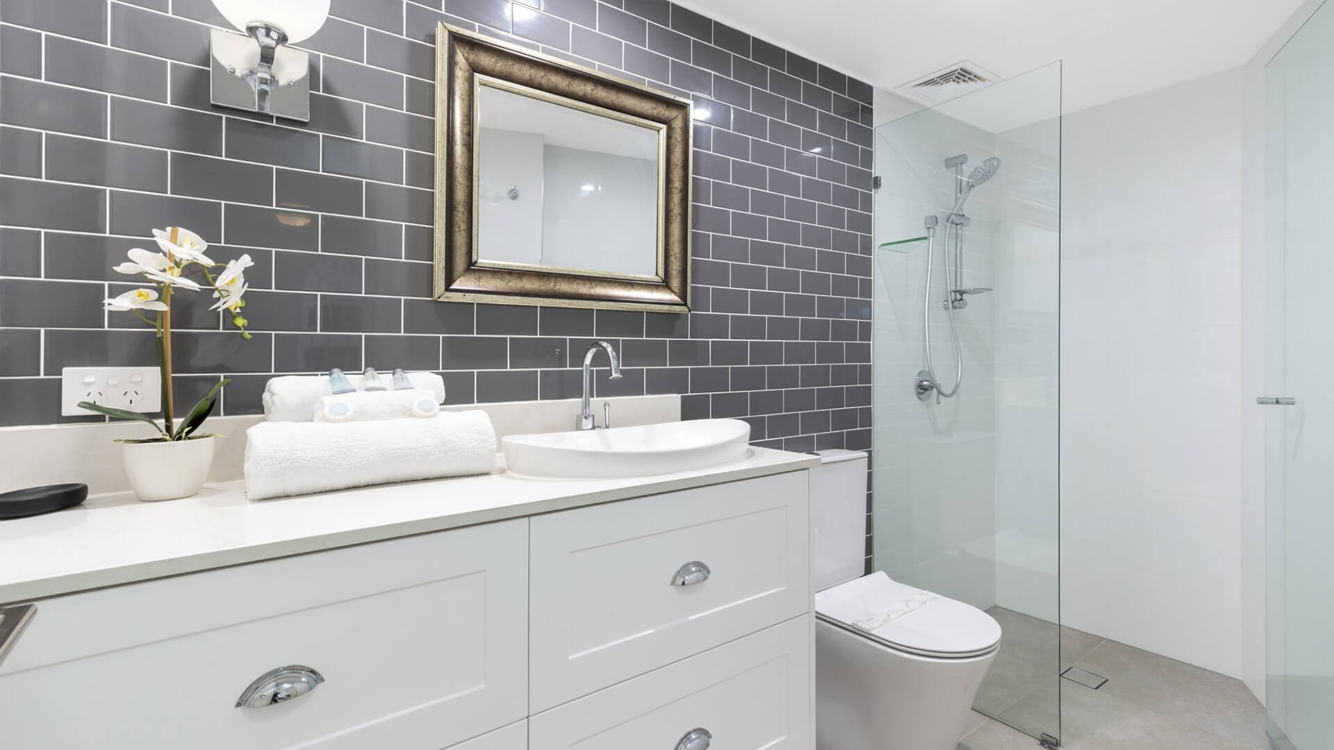 Modern bathroom in 1 Bedroom Superior Apartment at ULTIQA Burleigh Mediterranean Resort with walk-in shower and sleek finishes.