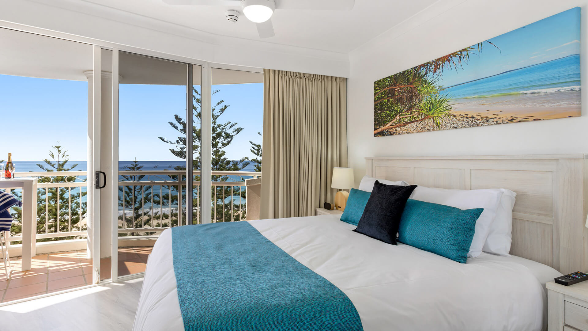 Bedroom with king bed and ocean-view balcony in 1 Bedroom Superior Ocean View Apartment at ULTIQA Burleigh Mediterranean Resort.