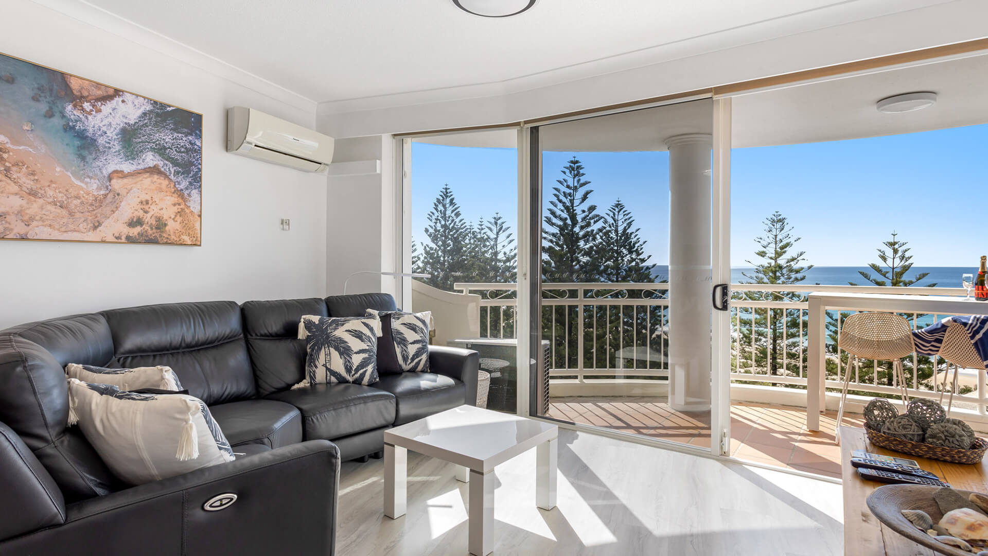 Living area of 1 Bedroom Superior Ocean View Apartment at ULTIQA Burleigh Mediterranean Resort with balcony and ocean views. 