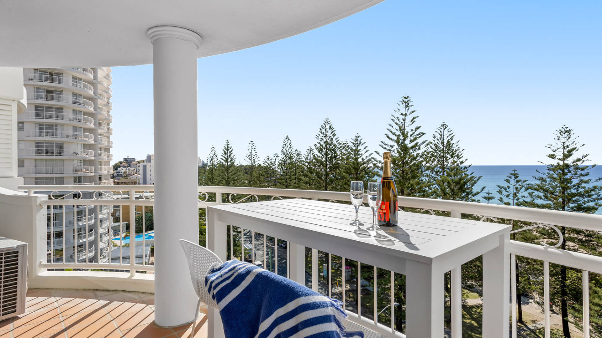 Private balcony with seating and ocean views in 1 Bedroom Superior Ocean View Apartment at ULTIQA Burleigh Mediterranean Resort.