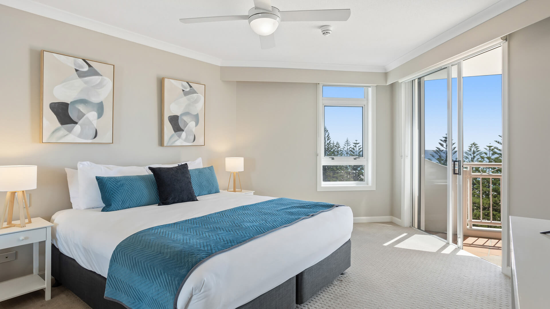 Master bedroom with king bed and private balcony in 2 Bedroom Garden View Apartment at ULTIQA Burleigh Mediterranean Resort.