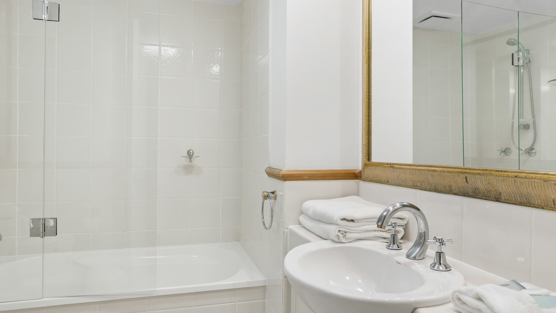 Main bathroom with shower-over-bath in 2 Bedroom Garden View Apartment at ULTIQA Burleigh Mediterranean Resort.