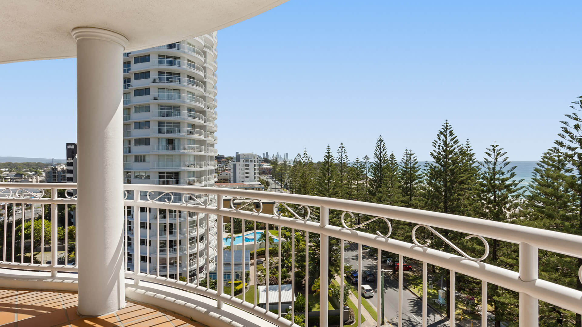Private balcony with views of Burleigh Heads, the ocean, and surrounding cityscape at ULTIQA Burleigh Mediterranean Resort.
