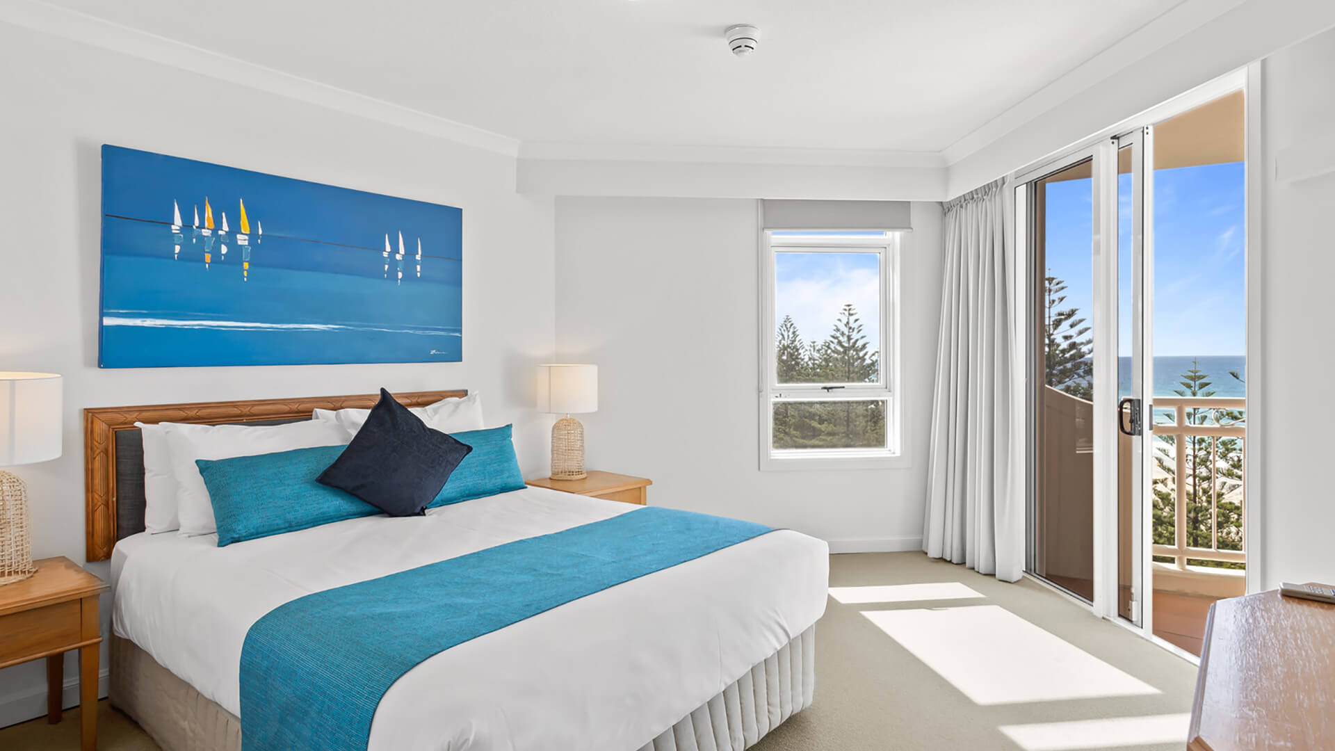 Bedroom with ocean-view balcony in 2 Bedroom Apartment at ULTIQA Burleigh Mediterranean Resort.