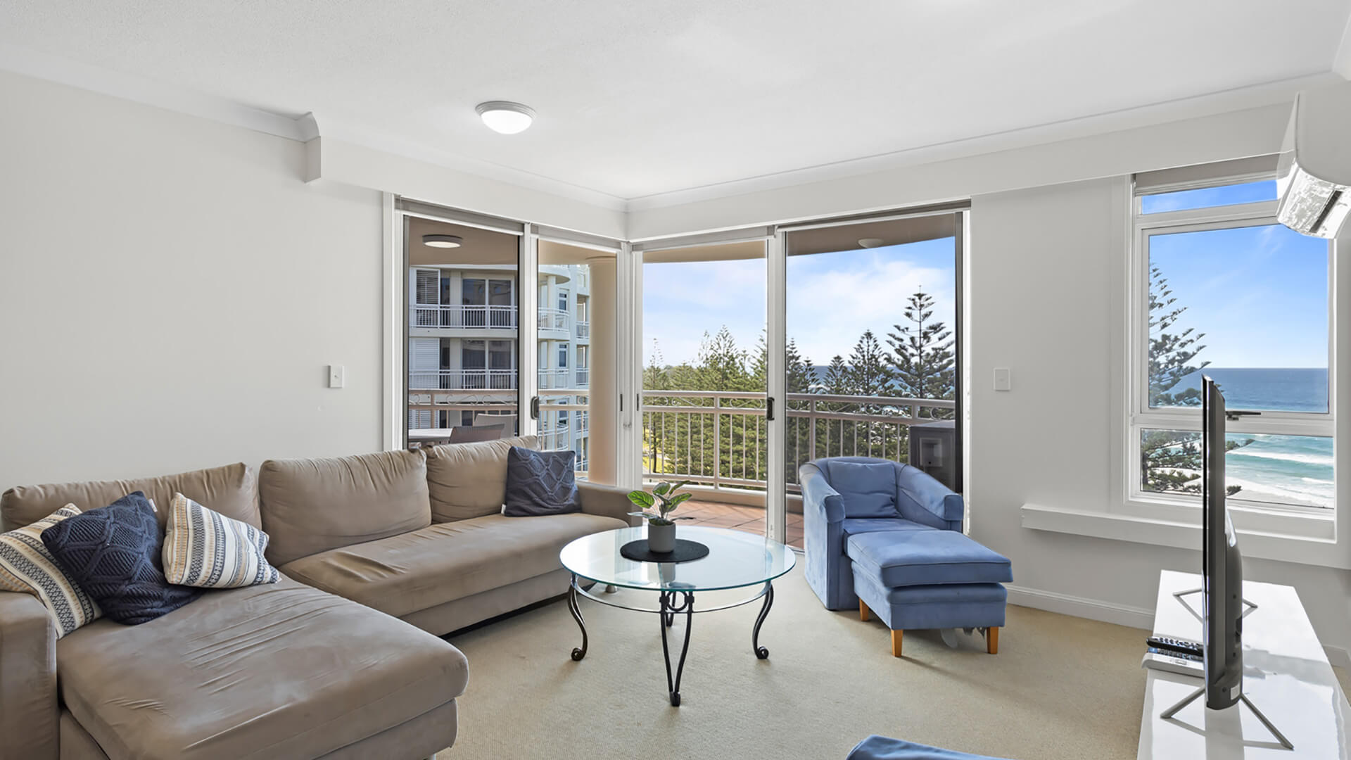 Spacious living area with ocean views in 2 Bedroom Apartment at ULTIQA Burleigh Mediterranean Resort.