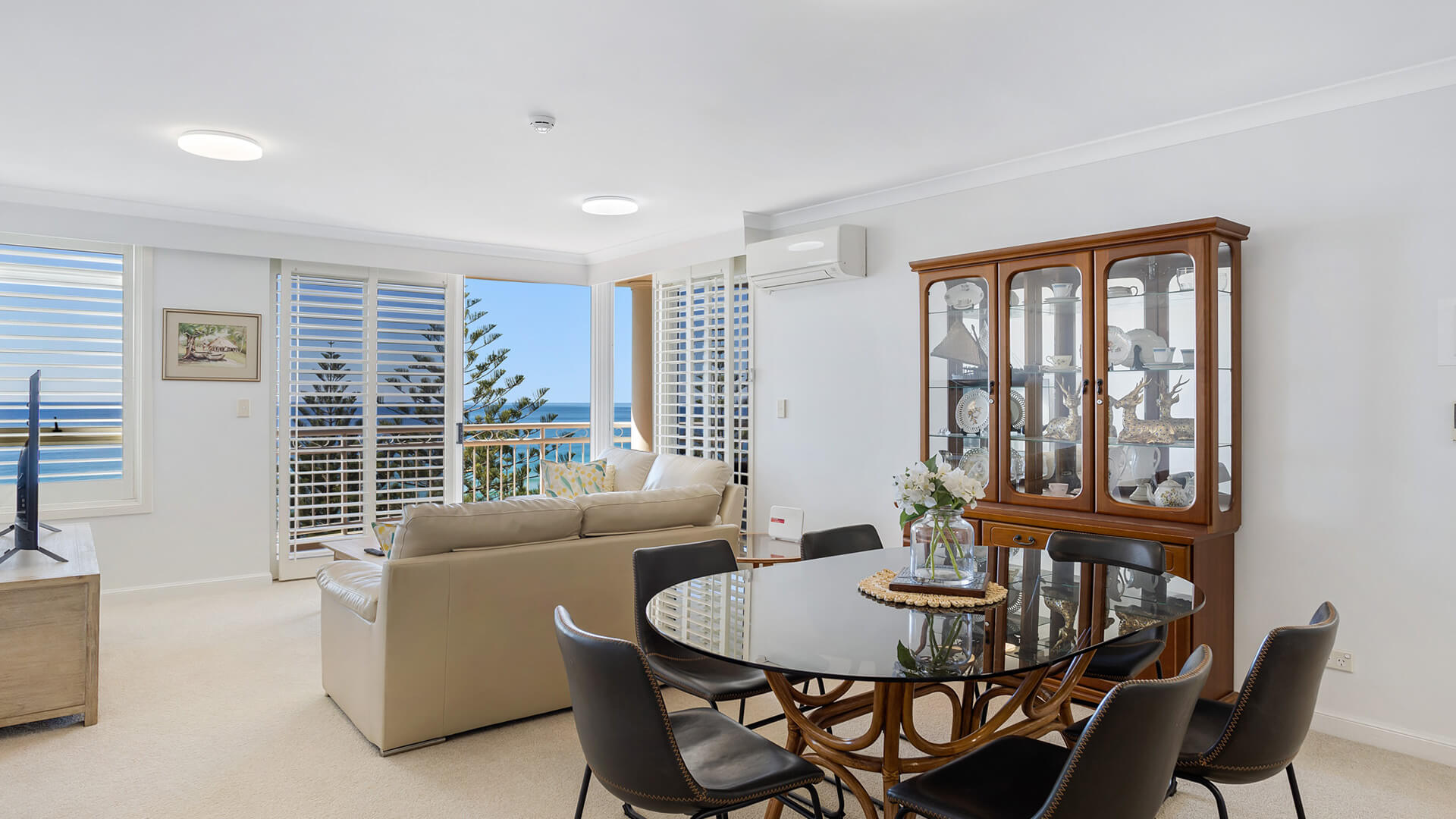 Dining and lounge area with ocean views in 2 Bedroom Apartment at ULTIQA Burleigh Mediterranean Resort.