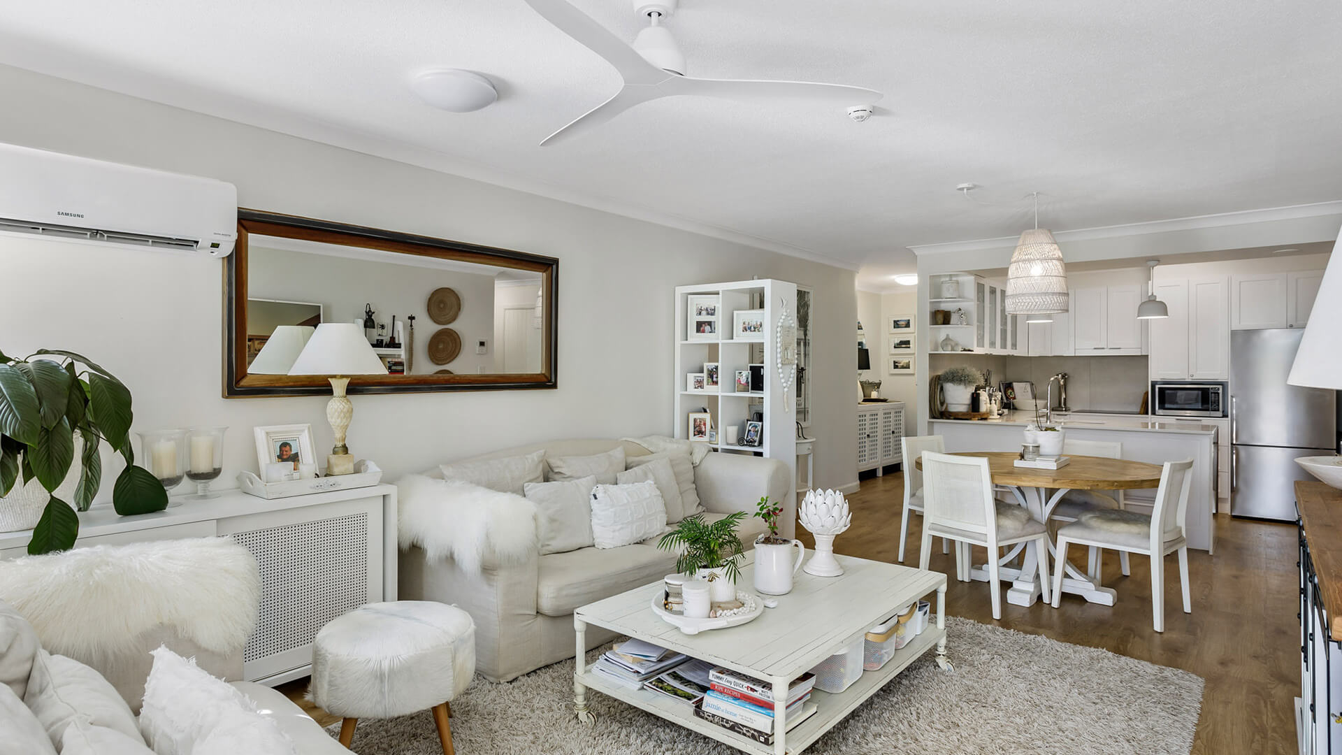 Open-plan living, dining, and kitchen in 2 Bedroom Superior Apartment at ULTIQA Burleigh Mediterranean Resort.