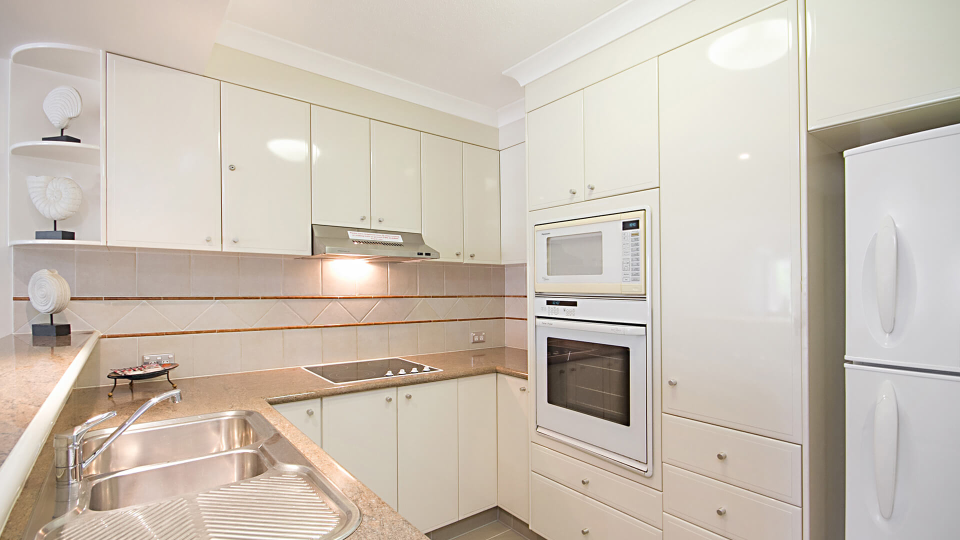 Fully equipped kitchen in 3 Bedroom Apartment at ULTIQA Burleigh Mediterranean Resort.