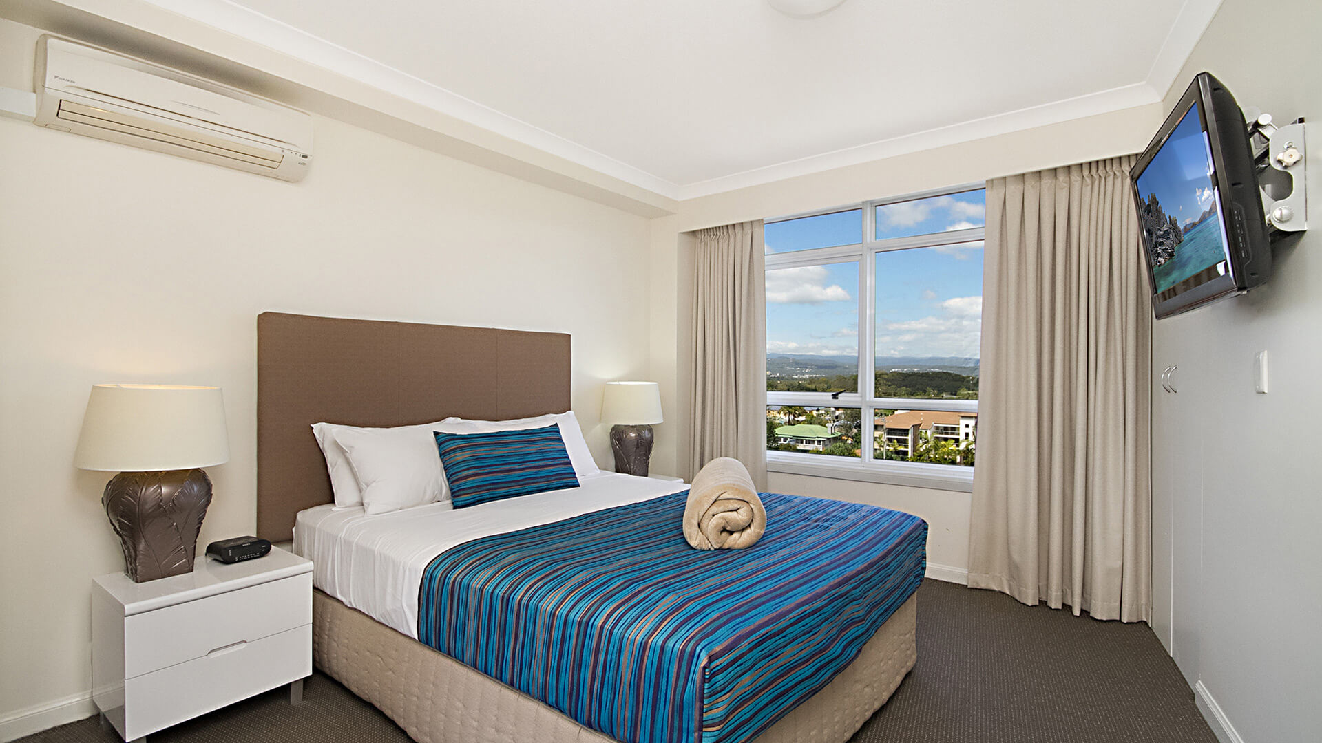 Master bedroom with king bed in 3 Bedroom Apartment at ULTIQA Burleigh Mediterranean Resort.