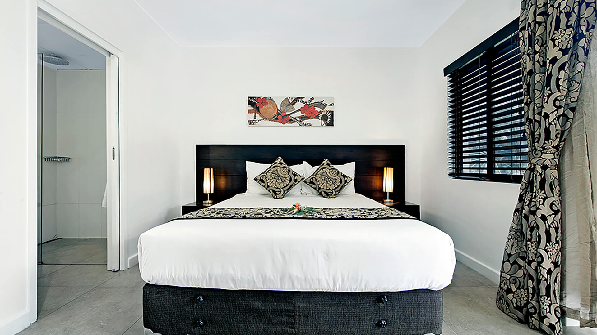 Bedroom with king bed, ensuite, and garden-view access in 2 Bedroom Apartment at ULTIQA Fiji.