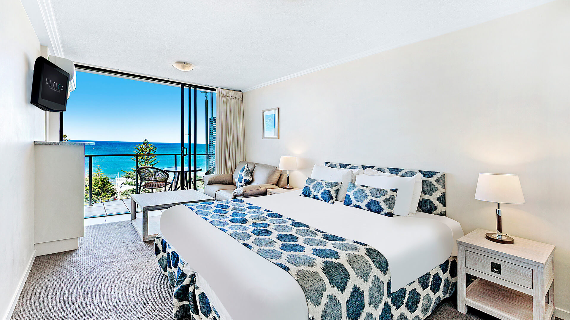 Ocean view studio with king bed, lounge area, and private balcony at ULTIQA Shearwater Resort.