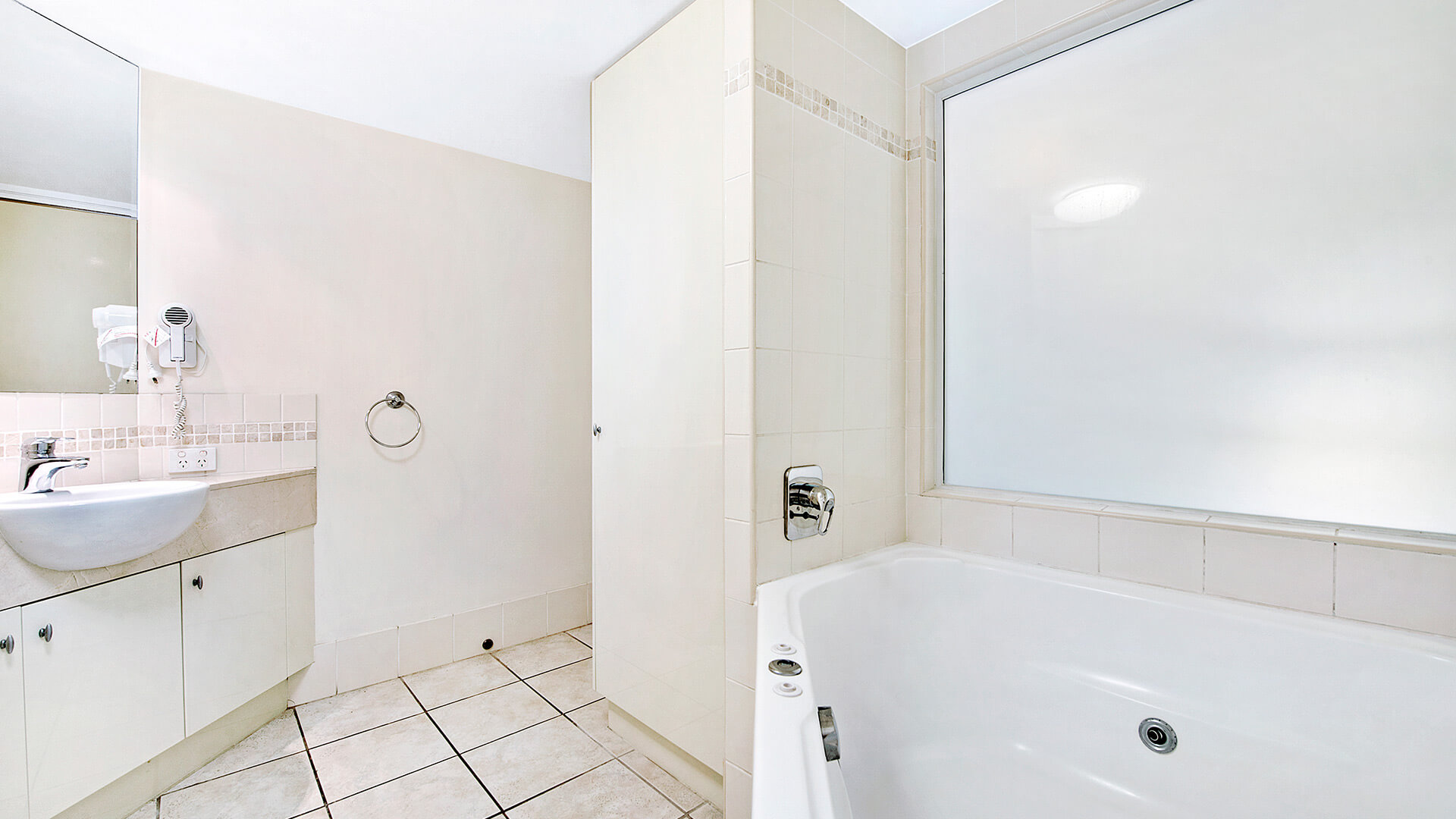 Bathroom with spa bath and separate shower in 1 Bedroom Apartment at ULTIQA Shearwater Resort.