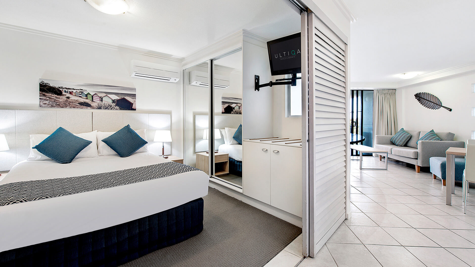 Bedroom with king bed and mirrored wardrobe in 1 Bedroom Apartment at ULTIQA Shearwater Resort.