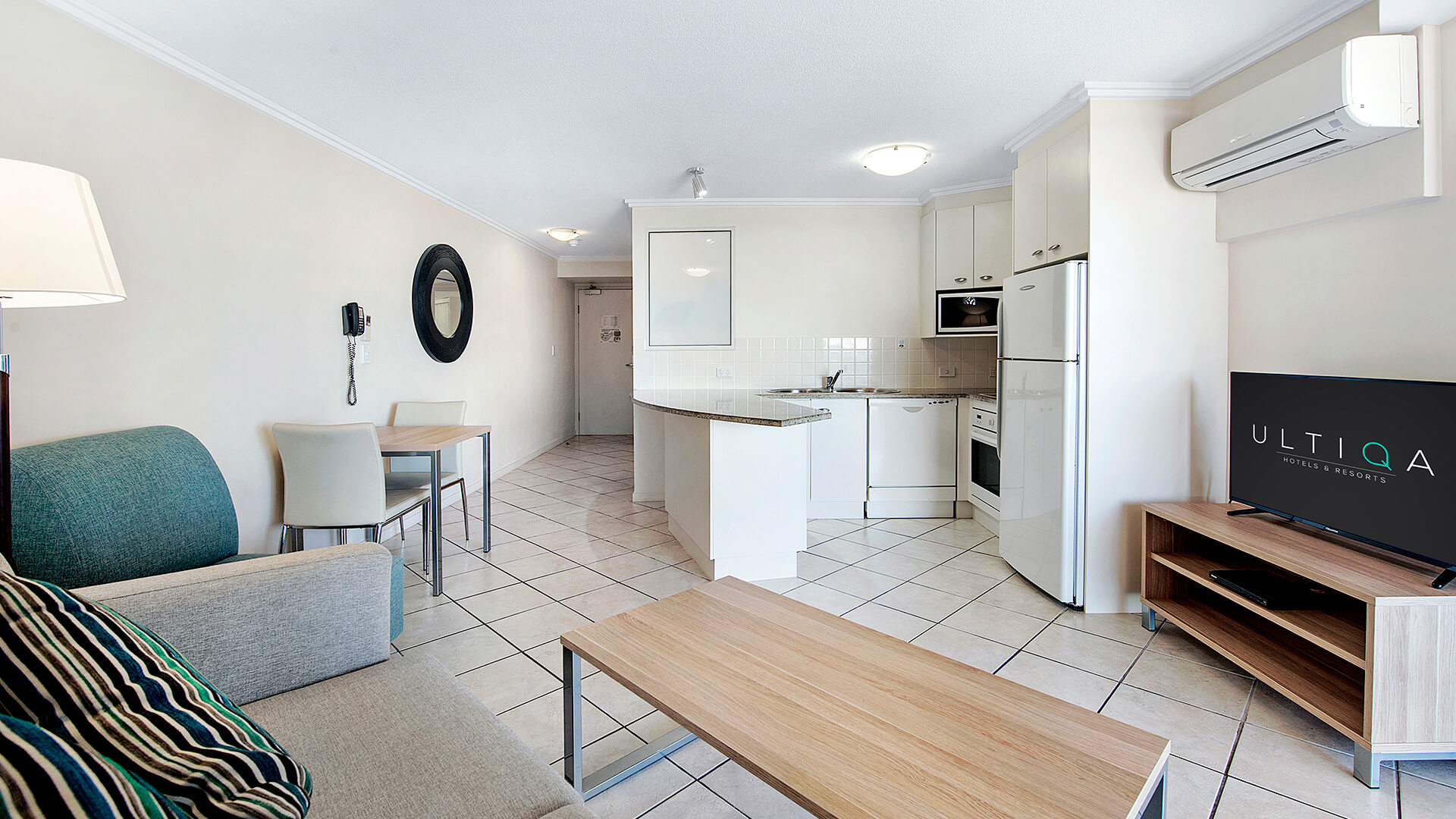Open-plan living and kitchen area in 1 Bedroom Apartment at ULTIQA Shearwater Resort.