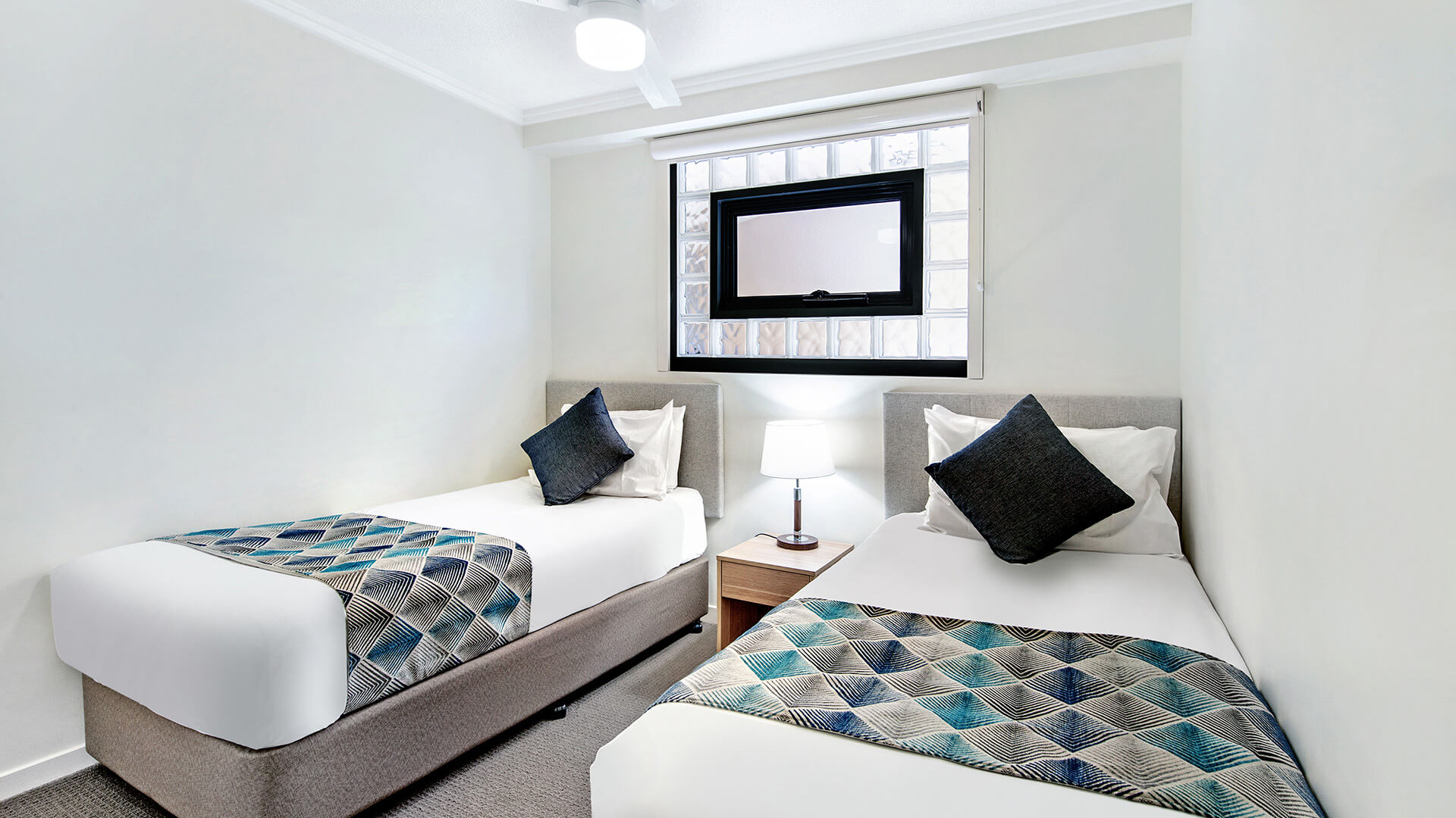 Second bedroom with two single beds in 2 Bedroom Apartment at ULTIQA Shearwater Resort.