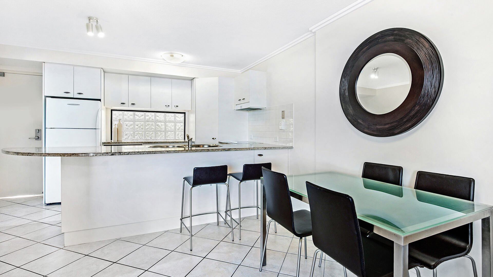 Kitchen and dining area in 2 Bedroom Apartment at ULTIQA Shearwater Resort.
