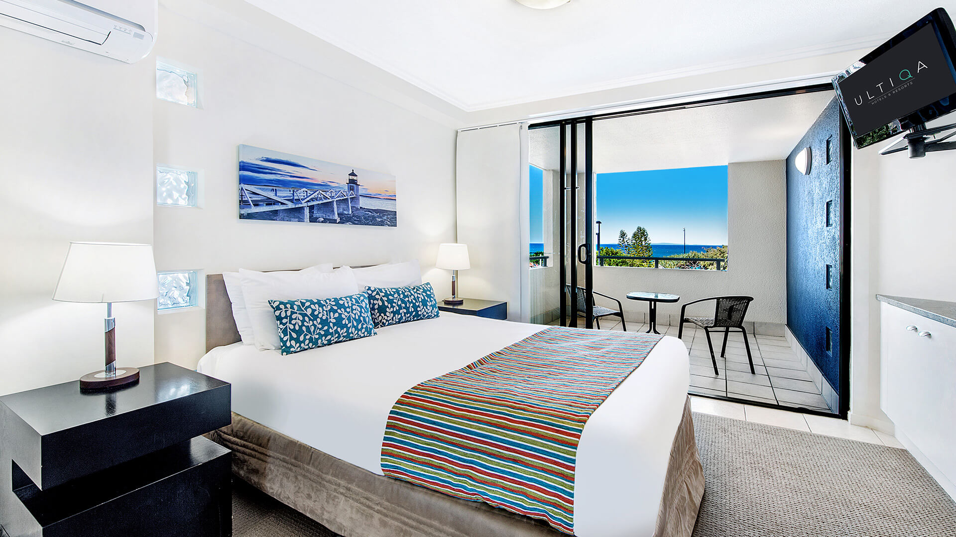 Bedroom with balcony access and ocean views in 2 Bedroom Apartment at ULTIQA Shearwater Resort.