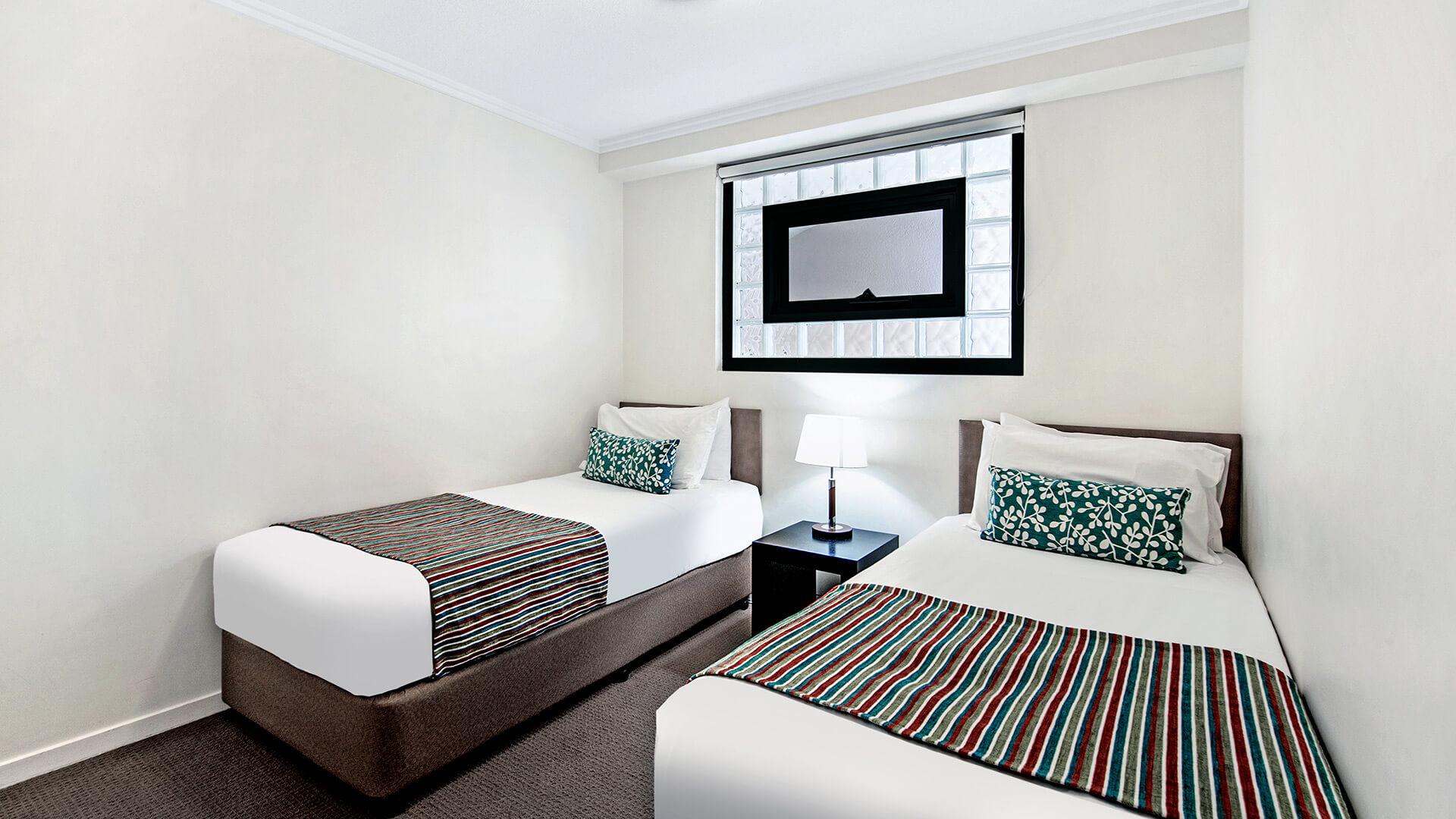 Second bedroom with twin beds in 2 Bedroom Apartment at ULTIQA Shearwater Resort.