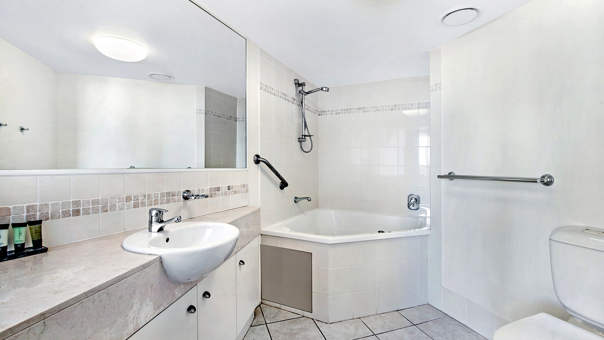 Bathroom with spa bath and separate shower in 2 Bedroom Apartment at ULTIQA Shearwater Resort.